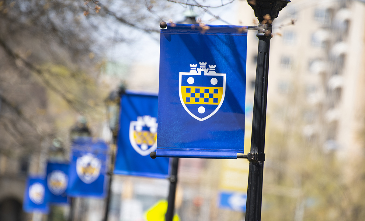 Pitt banners on campus light posts